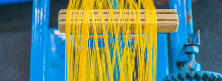 image of yellow silk fiber roll in factory process.