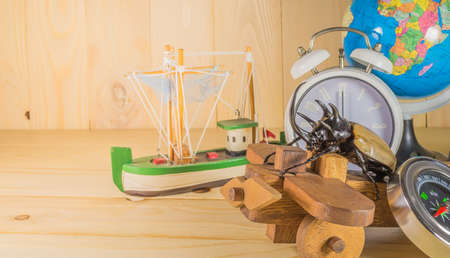 image of five horn beetle and wooden plane on  pine wood table background.(selective focus on beetle)の写真素材