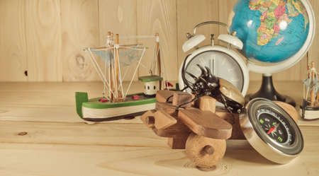 vintage tone image of five horn beetle and wooden plane on  pine wood table background.(selective...