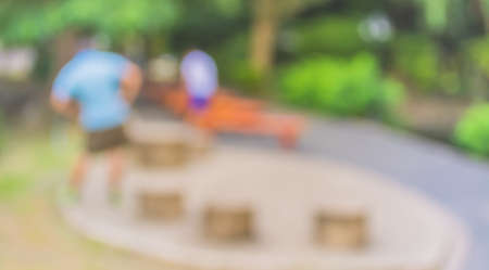 Blur image of people activities in park with bokeh on day time for background usage.の写真素材