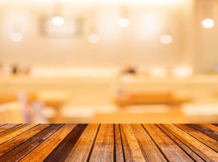 blur image of wood table and Abstract blurry sushi counter in vintage style decoration restaurant.