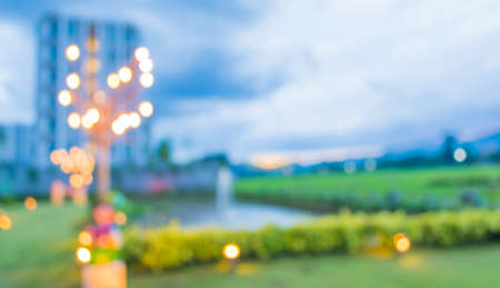 image of blur green field , pond and building with bokeh on evening time for background usage .の写真素材