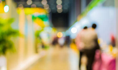 blurred image of people at trade show for background usage .