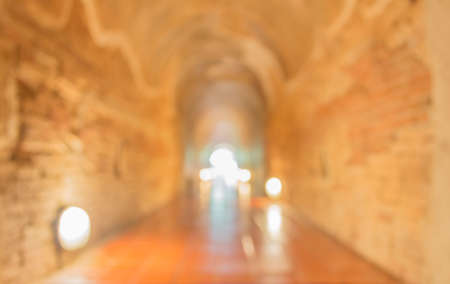 blur image of tunnel and light at the end.
