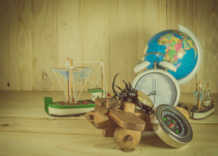 vintage tone image of five horn beetle and wooden plane on  pine wood table background.(selective focus on beetle)の写真素材