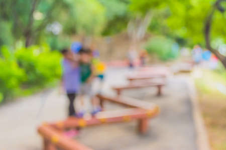 Blur image of people activities in park with bokeh on day time for background usage.の写真素材