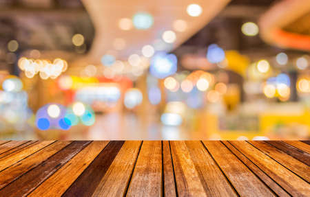 blurred image of wood table and trade show in shopping mall for background usage .の写真素材