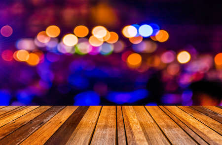 image of wood table and blurred bokeh background with colorful lights (blurred)