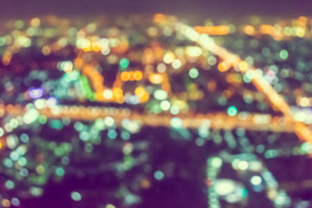 vintage tone blur image of Abstract city bokeh light backgroundの写真素材