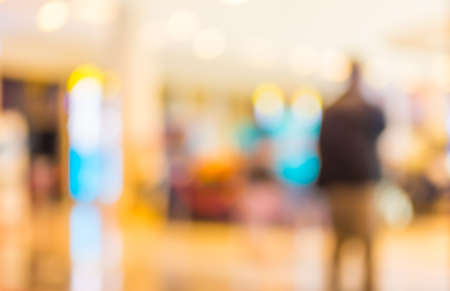 blurred image of modern shopping mall and people.