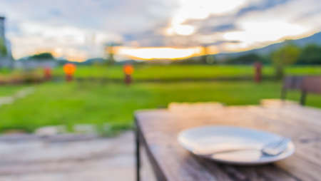 blur restaurant table on sunset time for background usage.の写真素材