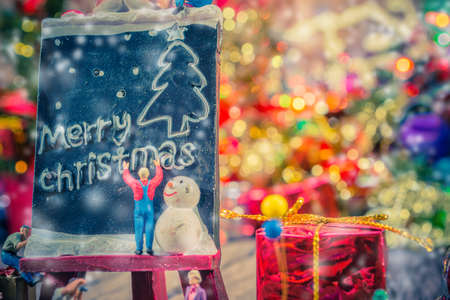 vintage tone image of dolls on wooden background with ornaments in Christmas timeの写真素材