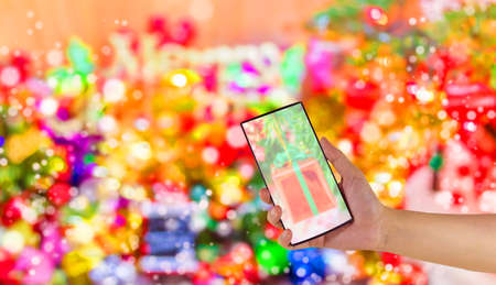 concept idea background image of hand using phone with ornaments in Christmas time .の写真素材