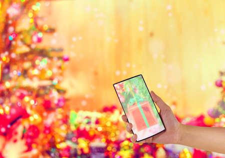 concept idea background image of hand using phone with ornaments in Christmas time .の写真素材