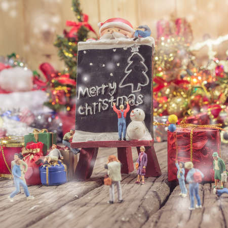 vintage tone image of dolls on wooden background with ornaments in Christmas timeの写真素材