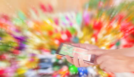 concept idea background image of hand using phone with ornaments in Christmas time .