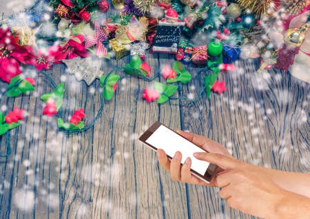 concept idea background image of hand using phone with ornaments in Christmas time .の写真素材