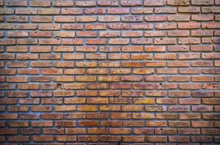 red brick wall texture grunge background with vignetted corners of image.の写真素材