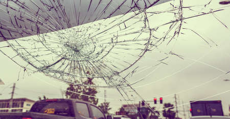 Selective focus image on Broken car windshield take photo from inside from accident of car.(vintage...