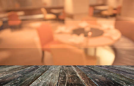 Abstract blur image of empty restaurant with wood table and chairs for background usage.(vintage tone)の写真素材