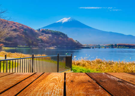 wood table and blur image of "fuji" mountain in japan for background usage .の写真素材