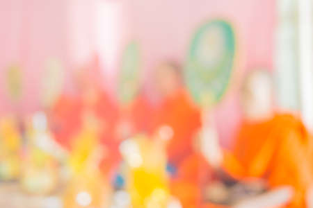 blur image of monk praying in thai culture ceremony.の写真素材