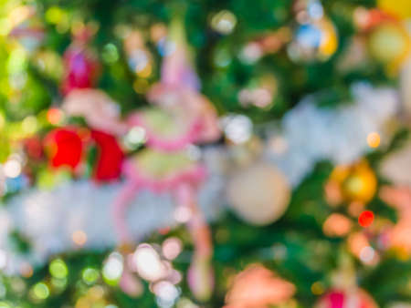 blur image of christmas ornaments and vary of decoration on pine tree background.の写真素材