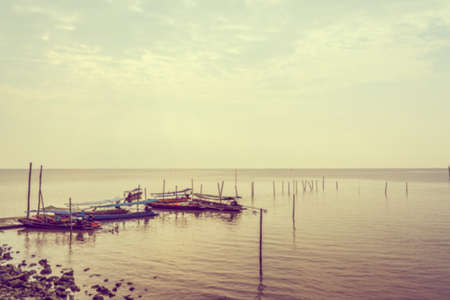 vintage tone blur image of small boat in seaport.の写真素材