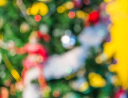 blur image of christmas ornaments and vary of decoration on pine tree background.の写真素材