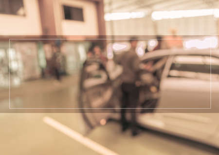 blur image of technician fixing car windshield in ther garage for background usage.の写真素材