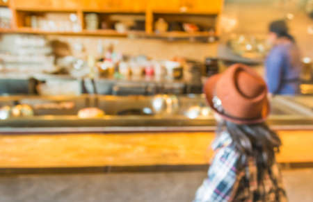 blur image of japan restaurant and lady customer waiting for her meal for background usage.の写真素材