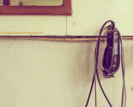 vintage tone image of old  Hair clipper in haircut shop for background usage.の写真素材