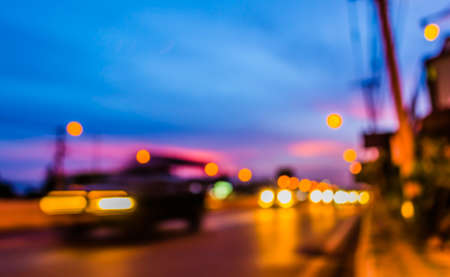 image of blur car on road in evening for background usage. (vintage tone)の写真素材