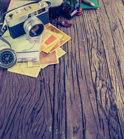 image of Retro camera and vary of decoration on wood table background(vintage color tone)