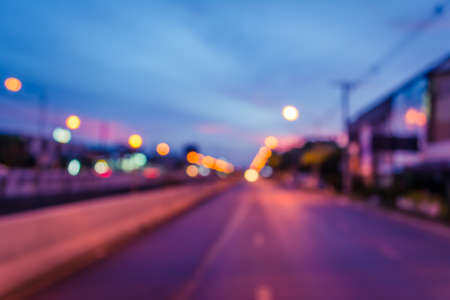 image of blur car on road in evening for background usage. (vintage tone)の写真素材