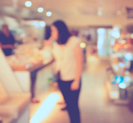Customer in Coffee shop blur background with bokeh image.(vintage tone)