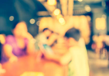 Coffee shop blur background with bokeh image.(vintage tone)の写真素材