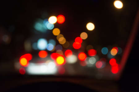 blur image of people driving car on night time for background usage.(take photo from inside)