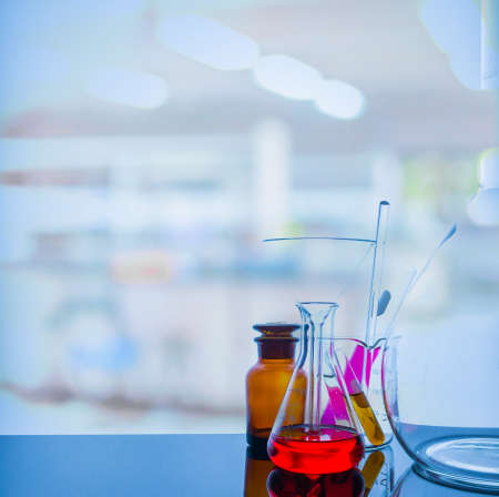 Lab glassware with blur laboratory in background.の写真素材