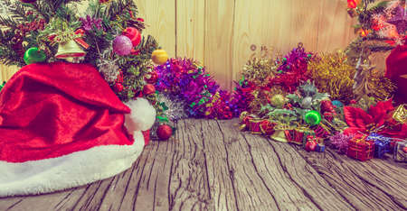 vintage tone image of christmas ornaments and vary of decoration on wood background.の写真素材