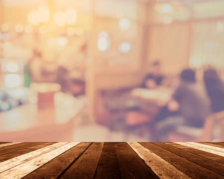 image of selective focus on surface of wood table and blur people at japanese  buffet catering room for background usage .の写真素材