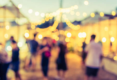 vintage tone blur image of night festival on street blurred background with bokeh .