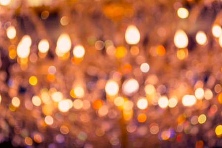 image of blur chandelier with bokeh in orange light tone for background usage .の写真素材