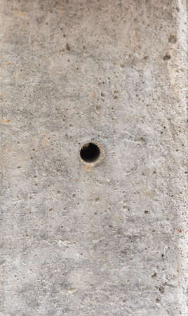 close up image of hole in electric pole and cement texture.の写真素材