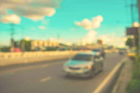 image of blur car on road in evening for background usage. (vintage tone)の写真素材