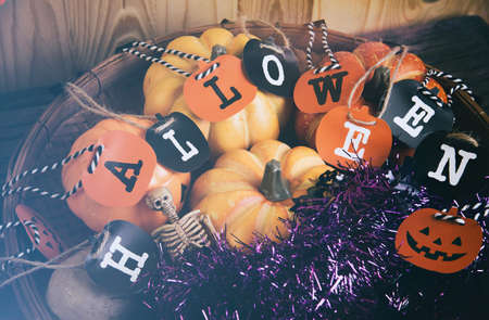 vintage tone image of Halloween pumpkin and a variety of ornaments on a wood table with Wooden background .の写真素材