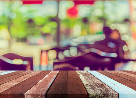 image of blur restaurant or coffee shop on day time with bokeh for background usage . (vintage tone)