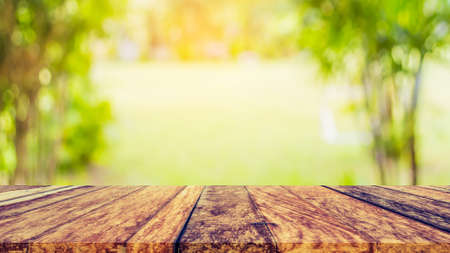 blur image of wood table and  Abstract Bokeh of tree green color background .の写真素材