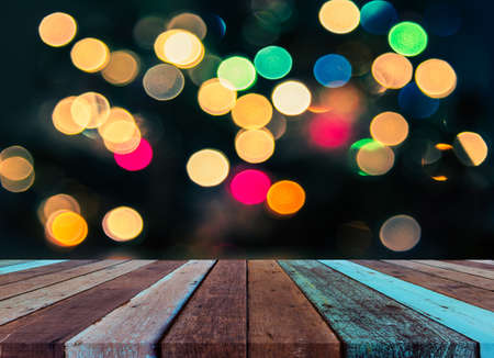 image of wood table and blurred bokeh background with colorful Christmas lights .の写真素材