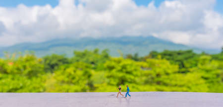 minifigure doll idea image of runner with blur beautiful big mountain on day time in background.の写真素材